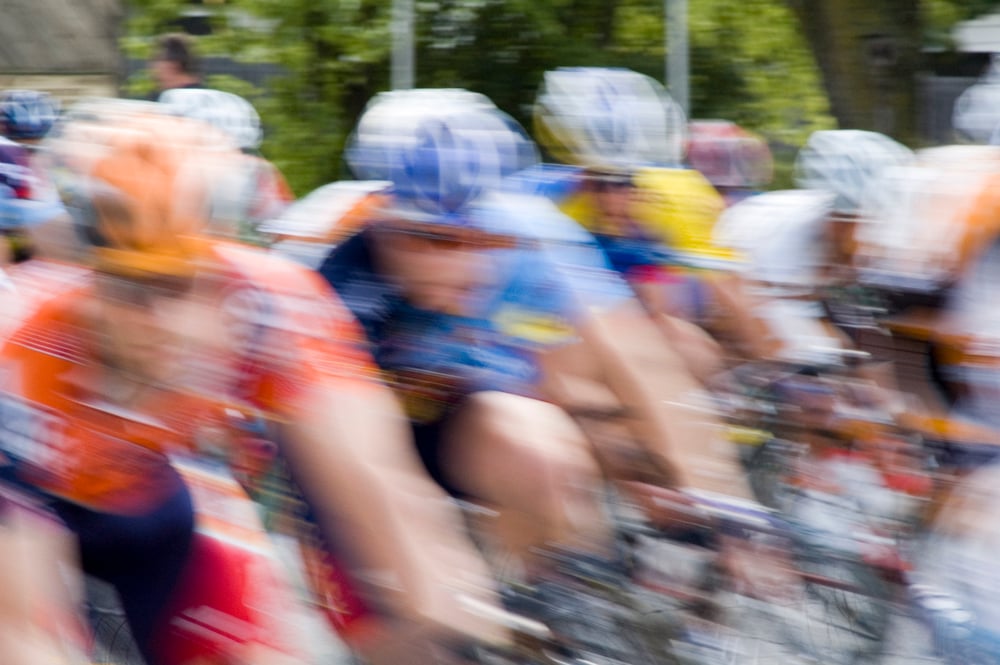 Bicycle racers speed toward camera